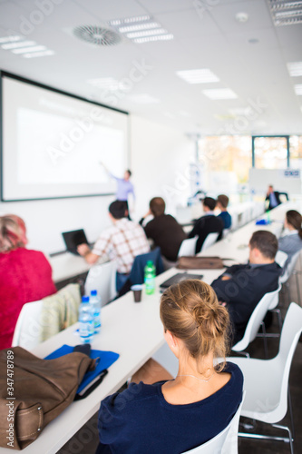 People in a conference room listening to a speech