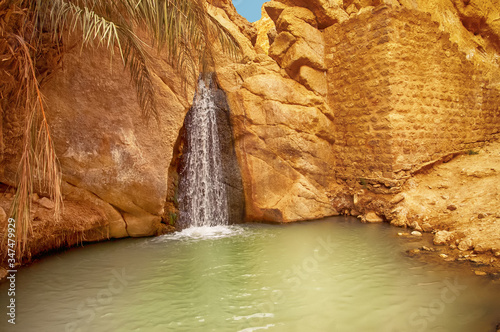 View of waterfall in mountain oasis Chebika, Sahara desert, Tunisia photo