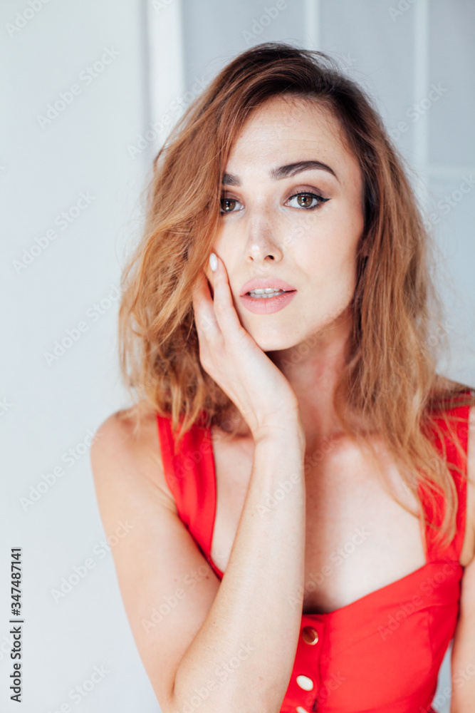 Portrait of a beautiful red woman in a red business dress at work in the office Portrait of a beautiful red woman in a red business dress at work in the office