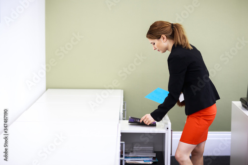 young woman tying up her office photo