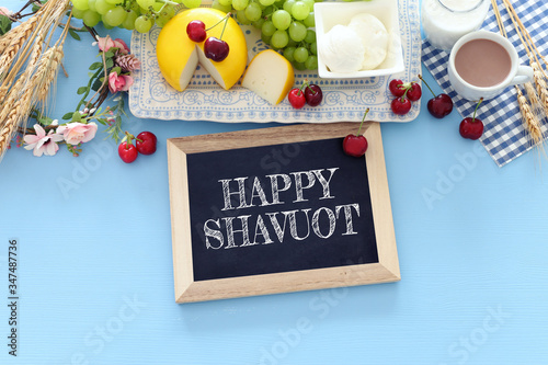 Top view photo of dairy products over pastel blue background. Symbols of jewish holiday - Shavuot
