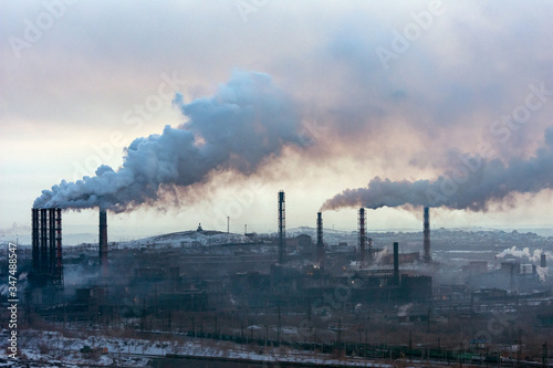 Plant view. Plant with pipes and smoke. Panorama of  industrial complex. Emissions of air pollutants. smoke from the chimney