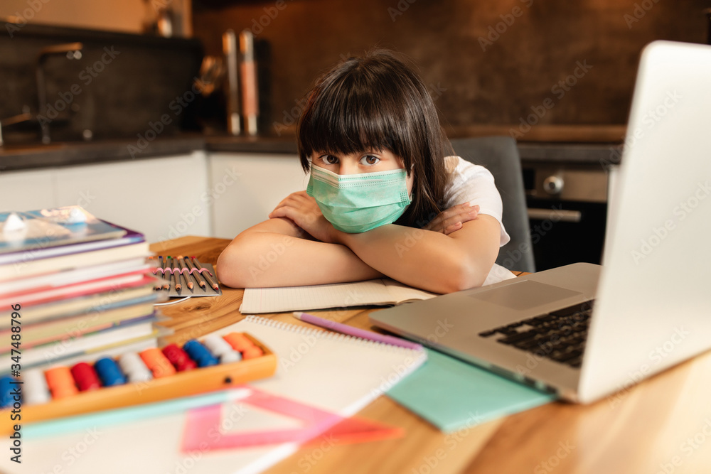 Schoolgirl study at home, social distance during quarantine, self-isolation, online education concept, home school. Online learning during pandemic Covid-19 Schoolgirl study at home, social distance during quarantine, self-isolation, online education concept, home school. Online learning during pandemic Covid-19