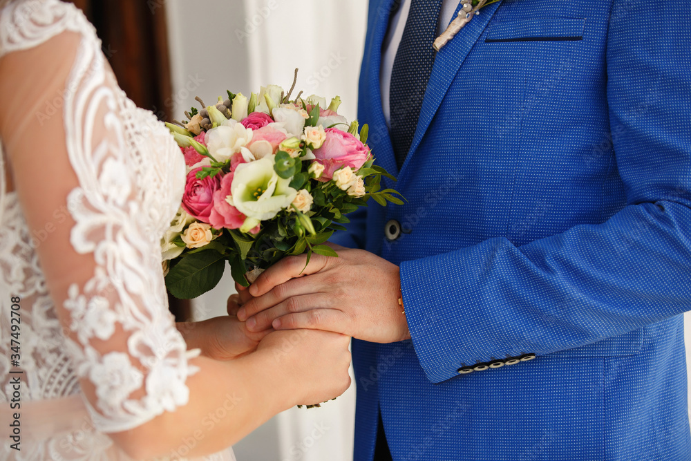 Wedding. Bride and groom holding wedding bouquet Wedding. Bride and groom holding wedding bouquet