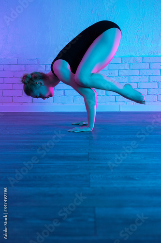 Fototapeta Naklejka Na Ścianę i Meble -  Sporty young woman doing yoga practice. Healthy life and natural balance between body and mental.