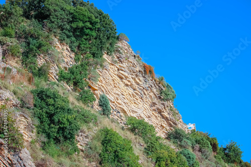 Beautiful layered cliffs on a background of blue sea.