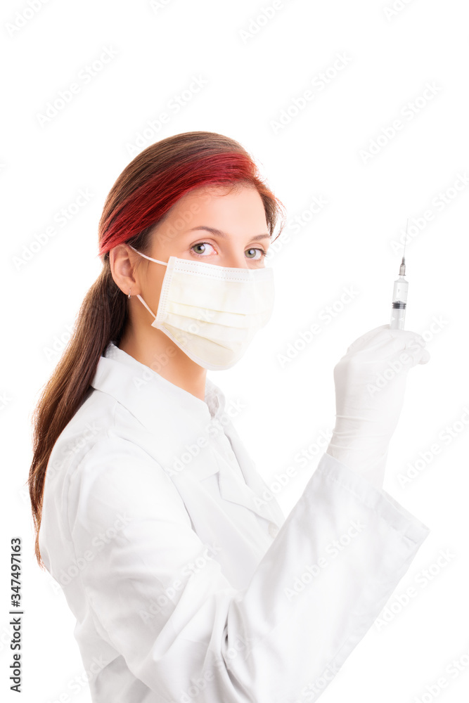 Female doctor with a protective mask and a syringe with needle Female doctor with a protective mask and a syringe with needle