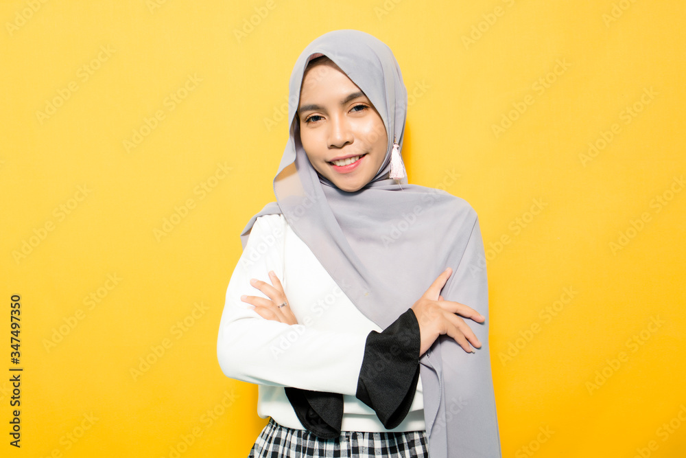 Portrait of Asian woman smiling with folded hands wearing hijab Portrait of Asian woman smiling with folded hands wearing hijab