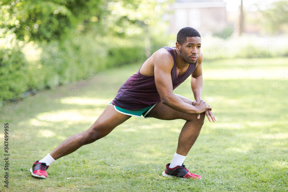 young man stretching in the park