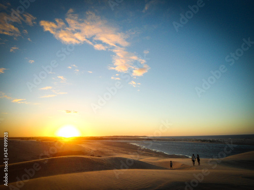 Amazing sunset in Jericoacoara beach in Ceara  Brazil  with three people silhouette. Famosu place