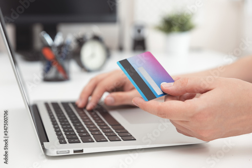 Online shopping, e-commerce. Credit card in hand.