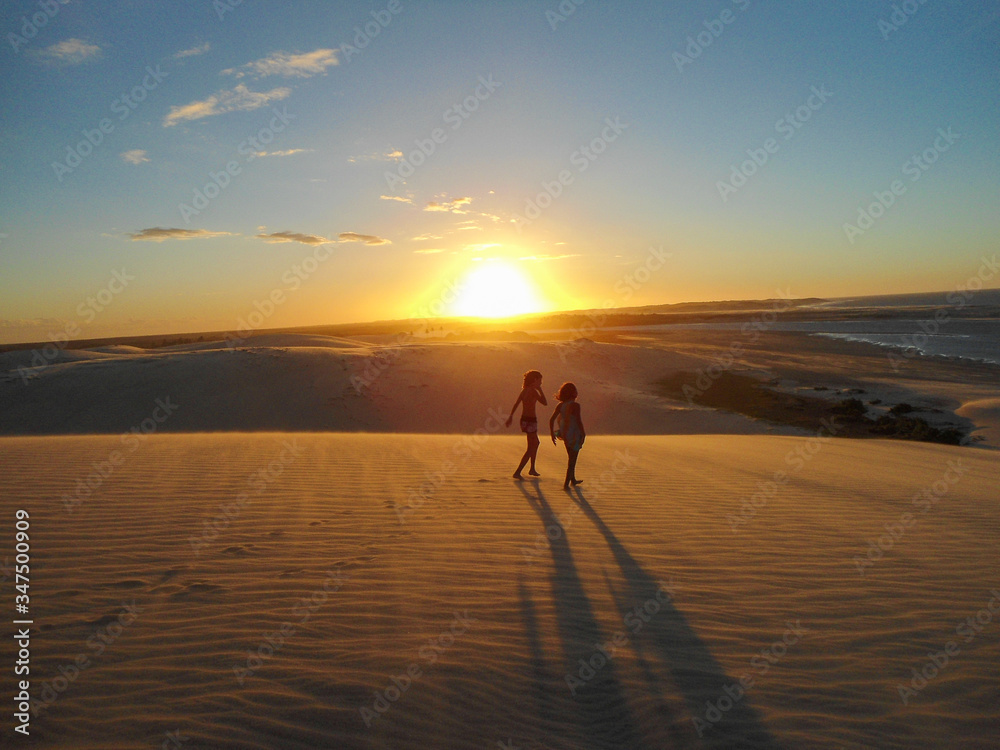 Amazing sunset in Jericoacoara beach in Ceara, Brazil, with people silhouette. Famosu place