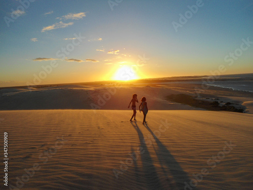 Amazing sunset in Jericoacoara beach in Ceara, Brazil, with people silhouette. Famosu place