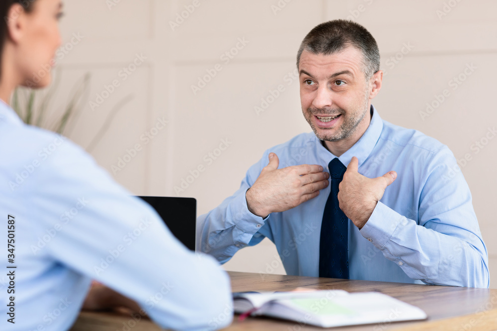 Man On Job Interview Talking With HR-Manager Sitting In Office