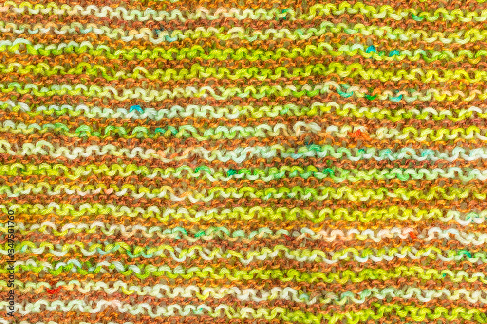 knitted fabric background with garter stitch pattern in green and brown