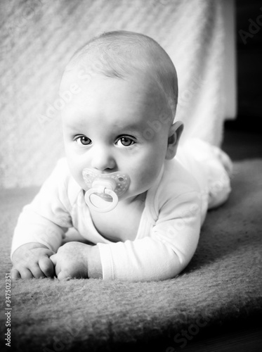 black-and-white photo of infant baby during timmy time