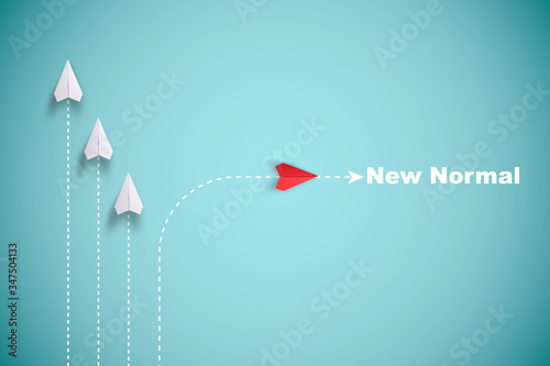 Red paper plane out of line with white paper to change disrupt and finding new normal way on blue background. Lift and business creativity new idea to discovery innovation technology. photo