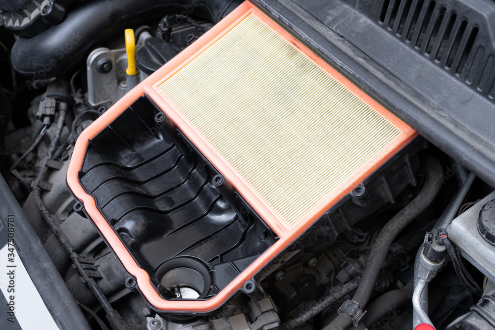 Open air box with new filter in car engine bay. Mechanic repair or vehicle maintenance concept.