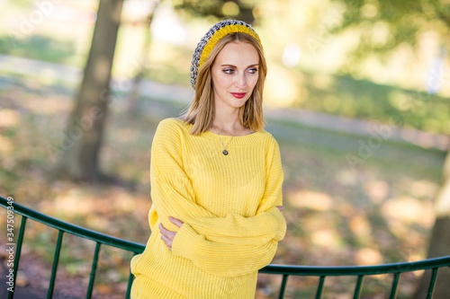 sad young woman in the park on her own photo