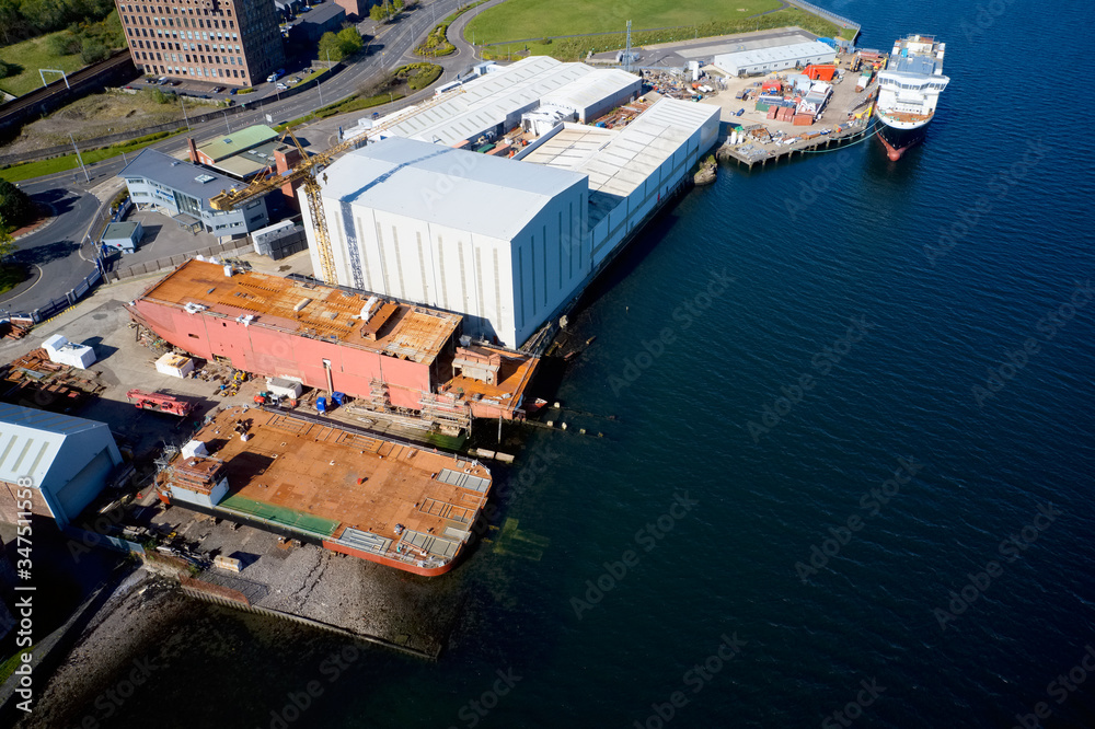 Shipbuilding construction ship aerial view at shipyard harbour with scaffold