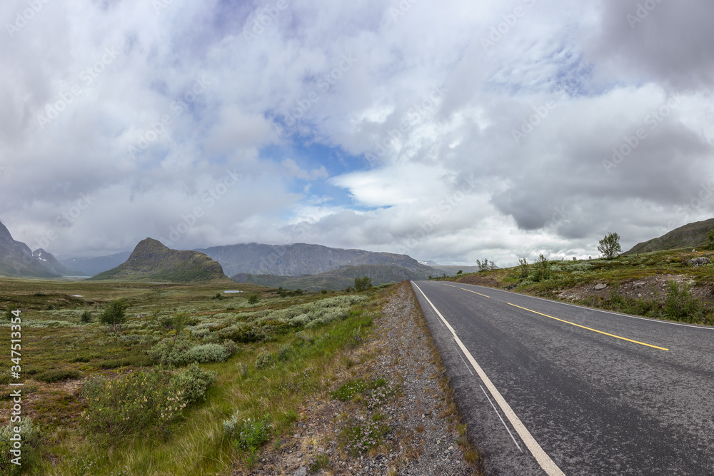 road passing in a valley between mountains in Norway road passing in a valley between mountains in Norway