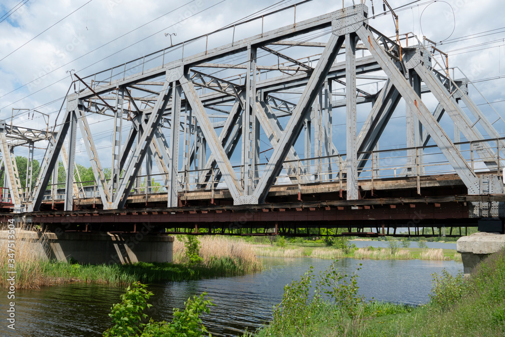 Railroad bridge over the river for trains for the delivery of industrial goods and the transport of passengers Railroad bridge over the river for trains for the delivery of industrial goods and the transport of passengers