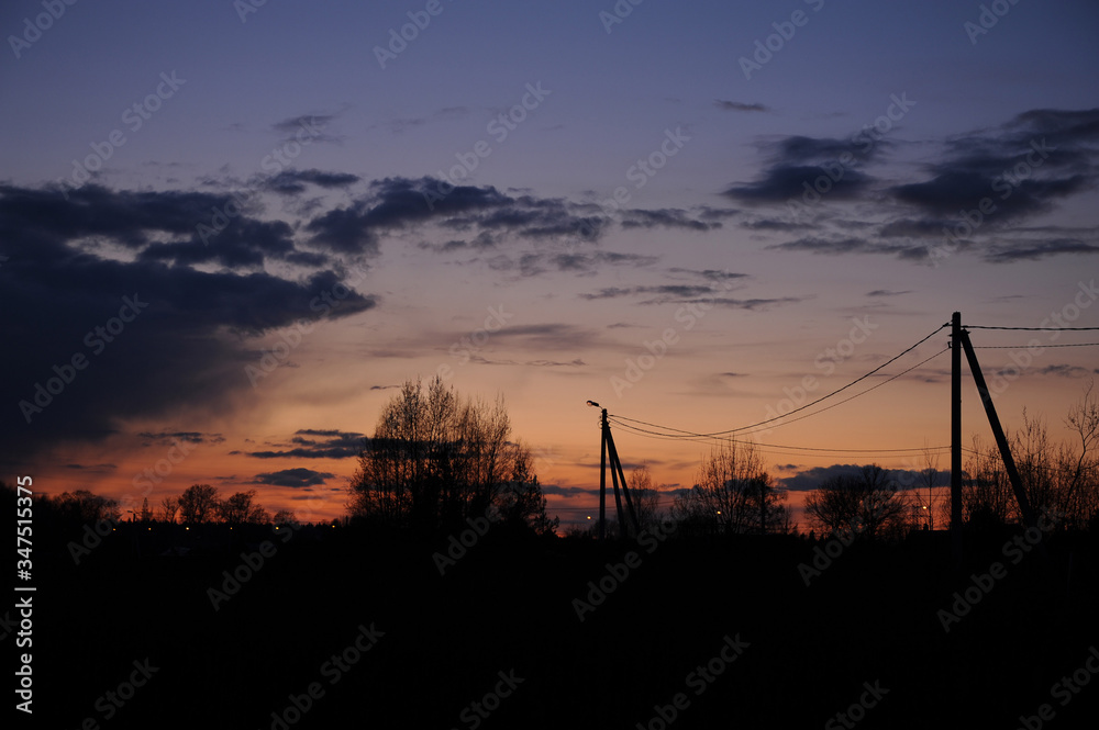 Power lines at sunset in the village