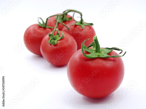 Organic garden tomatoes on white background