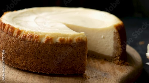 Slice of new york cheesecake closeup view. Taking piece of cake