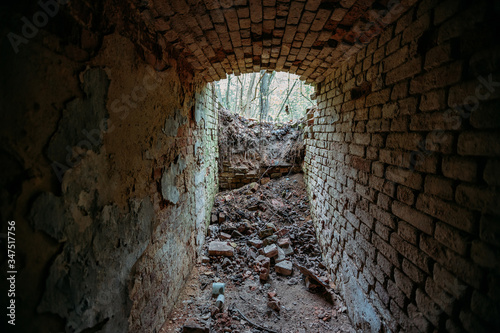 Historical underground red brick passage. Light at the end of tunnel © Mulderphoto