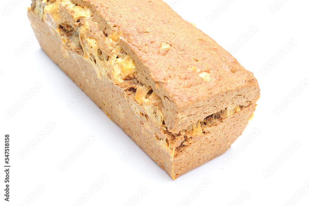 Homemade healthy bread made with spelt, gouda cheese and yeast, bread is imperfect but homemade and on a white background, the cheese is clearly visible within the bread Homemade healthy bread made with spelt, gouda cheese and yeast, bread is imperfect but homemade and on a white background, the cheese is clearly visible within the bread
