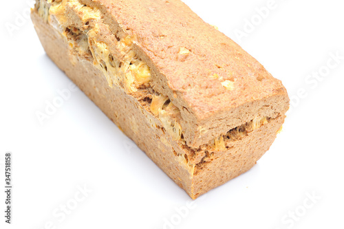 Homemade healthy bread made with spelt, gouda cheese and yeast, bread is imperfect but homemade and on a white background, the cheese is clearly visible within the bread