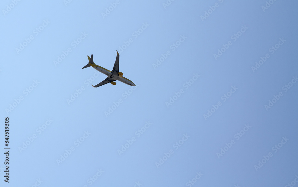 Flying plane against the blue sky view from below Flying plane against the blue sky view from below