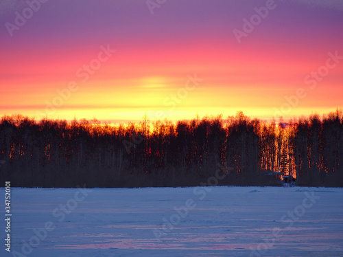 Beautiful colorful winter sunset by the lake in Finland