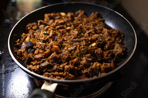 South Indian dish spicy beef fry Kerala, India. side dish ghee rice, appam, parotta, puttu, bread and chappathi, Kerala cuisine ,Buffalo roast / Meat pepper fry with coconut. India spices cooking,