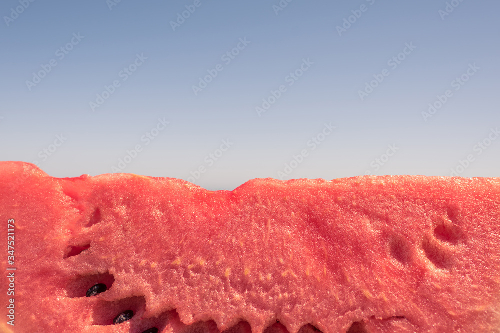 ripe piece of watermelon on the beach in a hot summer day. Concept ripe piece of watermelon on the beach in a hot summer day. Concept