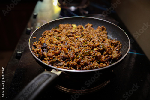 South Indian dish spicy beef fry Kerala, India. side dish ghee rice, appam, parotta, puttu, bread and chappathi, Kerala cuisine ,Buffalo roast / Meat pepper fry with coconut. India spices cooking,