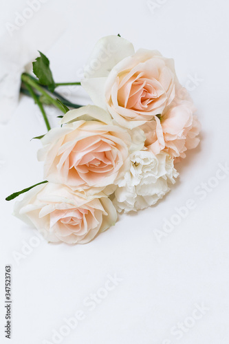 Bouquet of roses are glued to the white wall with tape. Creative concept flower.