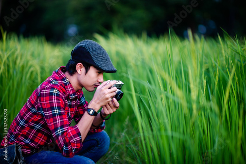 A man and a camera taking a photo and smiling happily Pictures for your business