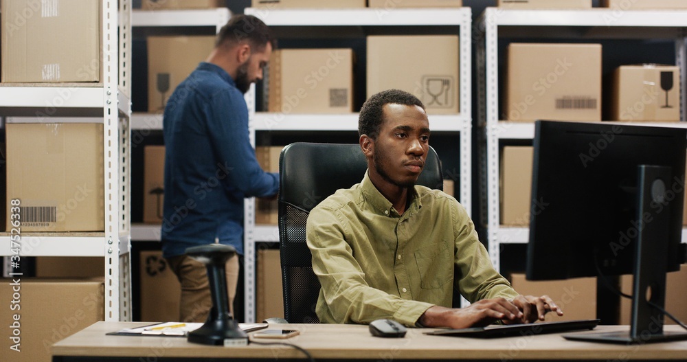 Delivery service concept. African american man using computer. Delivery service concept. African american man using computer.