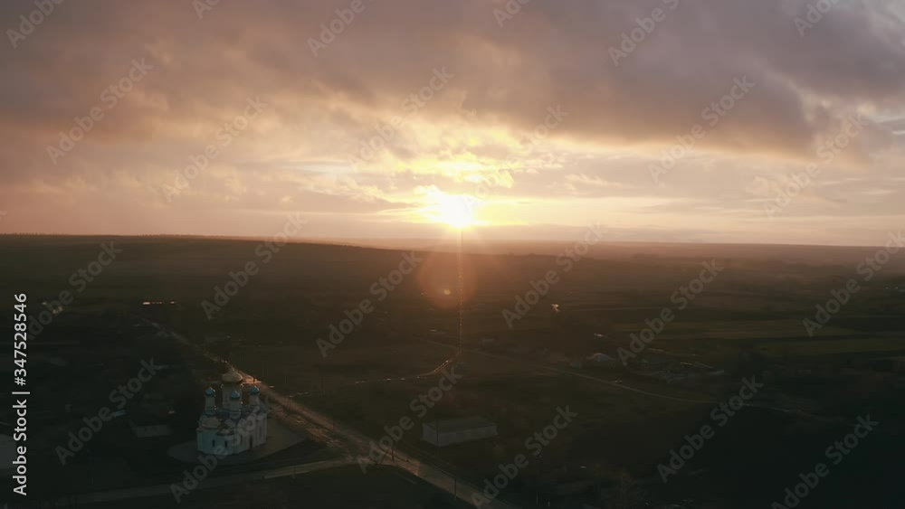 Church in a small town. epic sunset and smooth camera movement. golden clouds and lens flare Church in a small town. epic sunset and smooth camera movement. golden clouds and lens flare