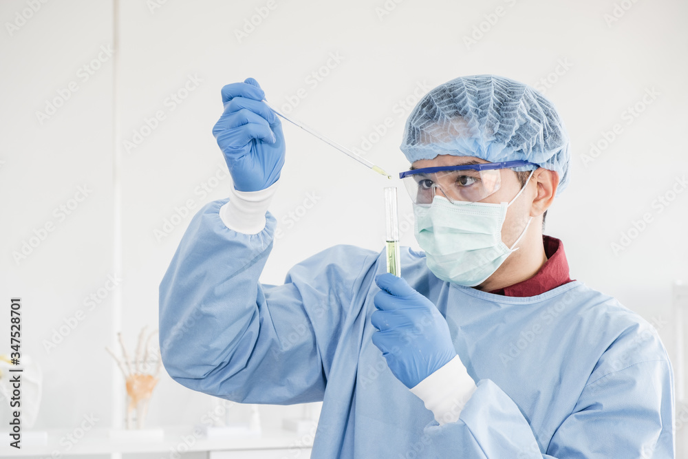 Science Labmask A male scientist with black hair wearing a blue protective lab coat ...