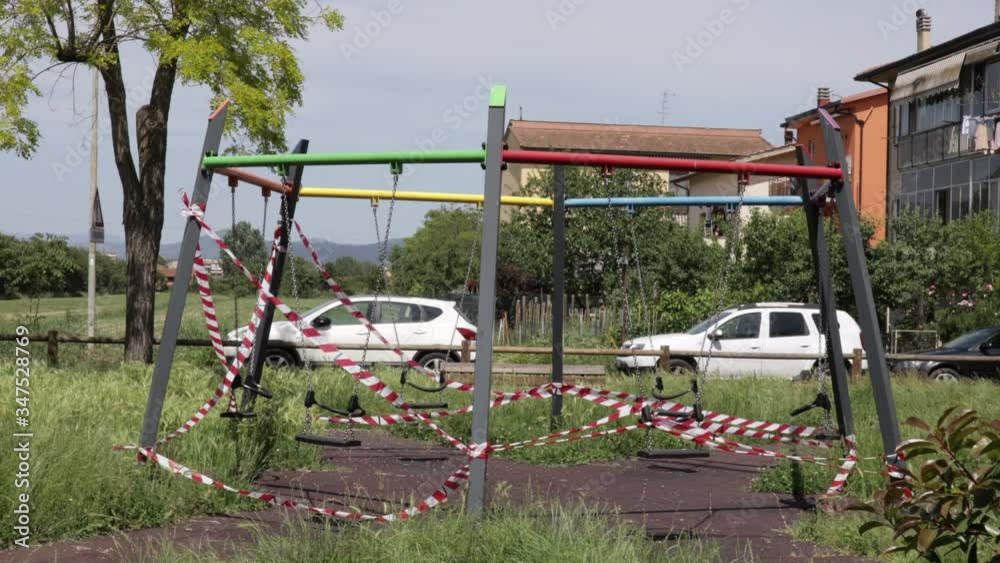Park Closed With Warning Signal Red And White Ribbon Because Of Quarantine. Coronavirus Covid 19 pandemic period Park Closed With Warning Signal Red And White Ribbon Because Of Quarantine. Coronavirus Covid 19 pandemic period