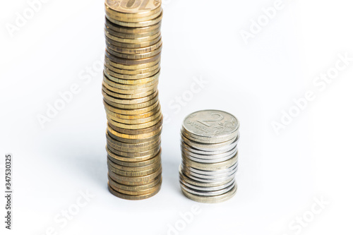 Pile of golden and silver coins stacked in columns. 2 russian rubles coins