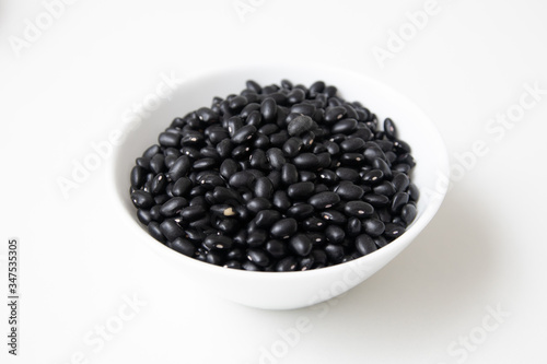 Pile of raw Brazilian Black Beans in a bowl. Also know as 'Feijao'