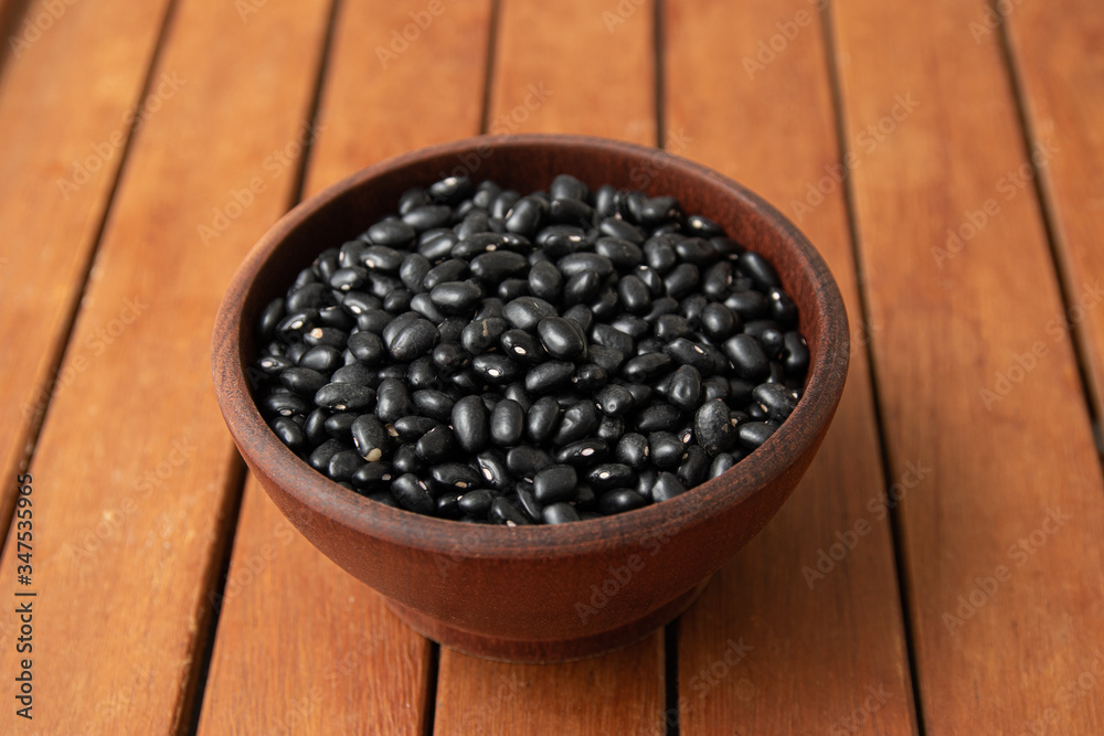 Pile of raw Brazilian Black Beans in a bowl. Also know as 'Feijao' Pile of raw Brazilian Black Beans in a bowl. Also know as 'Feijao'