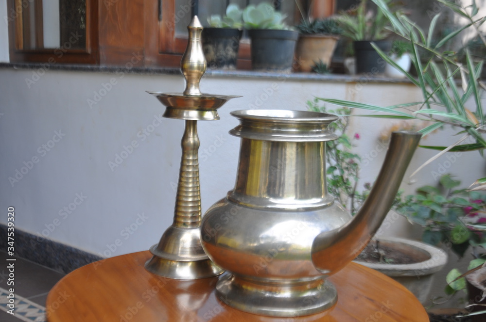 Typical Kerala Style metal lamp and water jar Typical Kerala Style metal lamp and water jar
