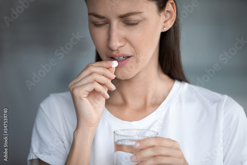 Canvas Print Close up image of unhealthy 35s female closed eyes suffers from migraine or hang