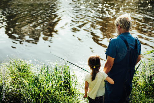 Grandpa and granddaughter fish, summer vacation with grandpa after a long separation