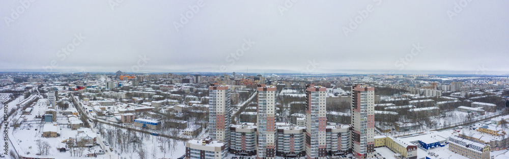 Panorama of the small town and Leninsky district in the central part of the city of Kirov on a winter day from above. Russia from the drone.